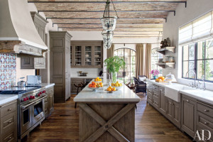 Antique Tunisian tile from Exquisite Surfaces makes a lively backsplash in Gisele Bündchen and Tom Brady’s Los Angeles kitchen, which interior design firm Joan Behnke & Assoc. appointed with Formations pendant lights, marble countertops from Compas Architectural Stone, custom-made alder cabinetry, an oak island, and a Wolf range. The architecture is by Landry Design Group.