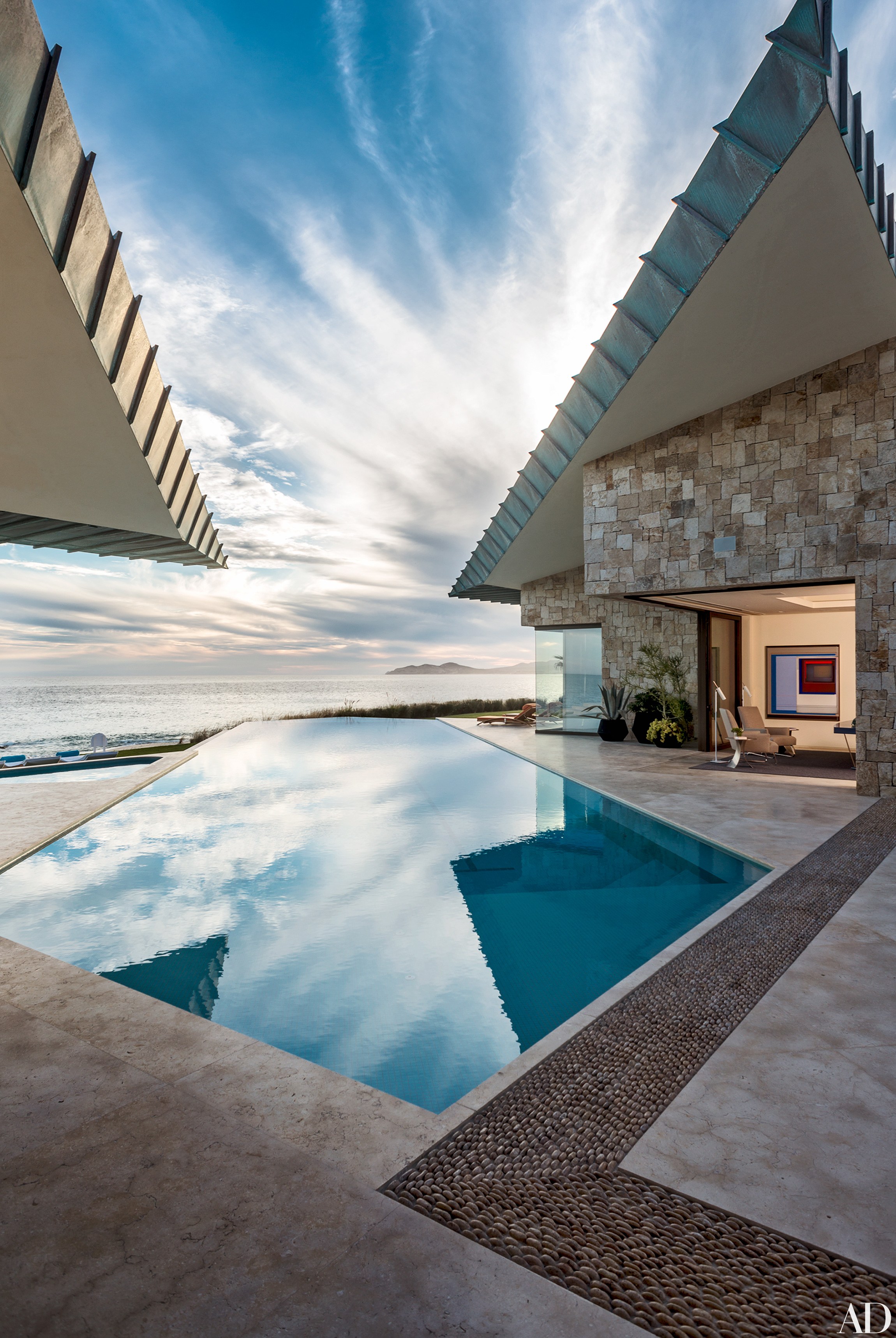 Mexican architect Diego Villaseñor conceived this geometric Venetian-tiled pool at a compound in Los Cabos to take advantage of the site’s spectacular ocean views. The marble terrace connects two copper-roofed pavilions.